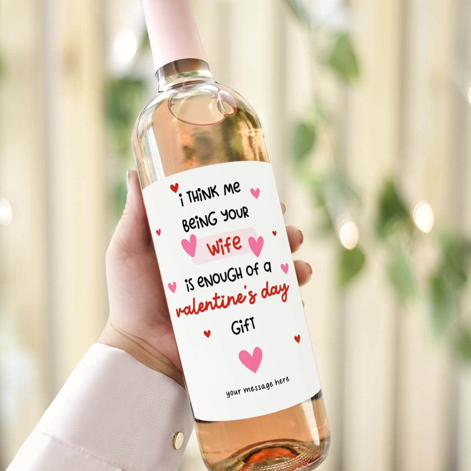 A Valentine’s Day wine label on a bottle reading "I think me being your wife is enough of a Valentine’s Day gift.