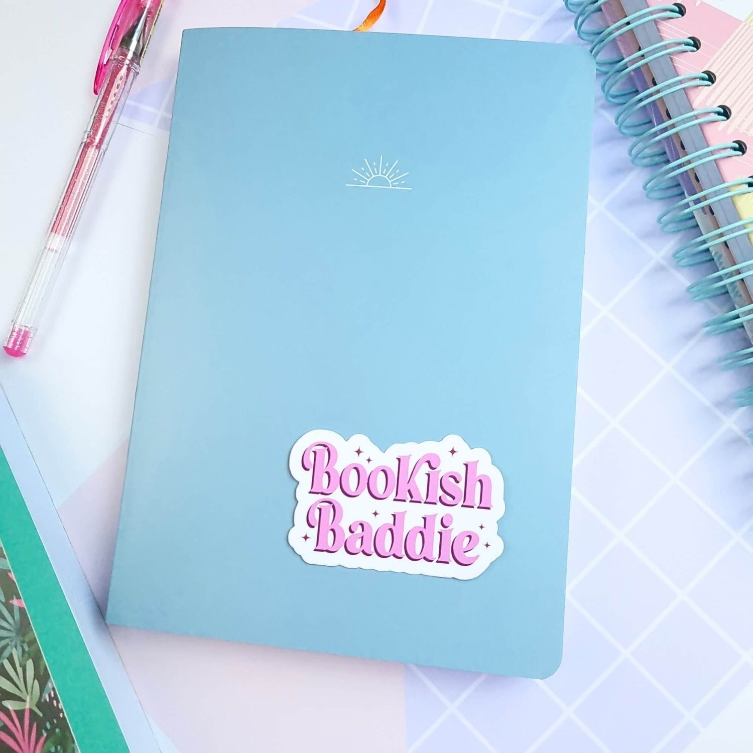 bookish baddie vinyl sticker on a notebook