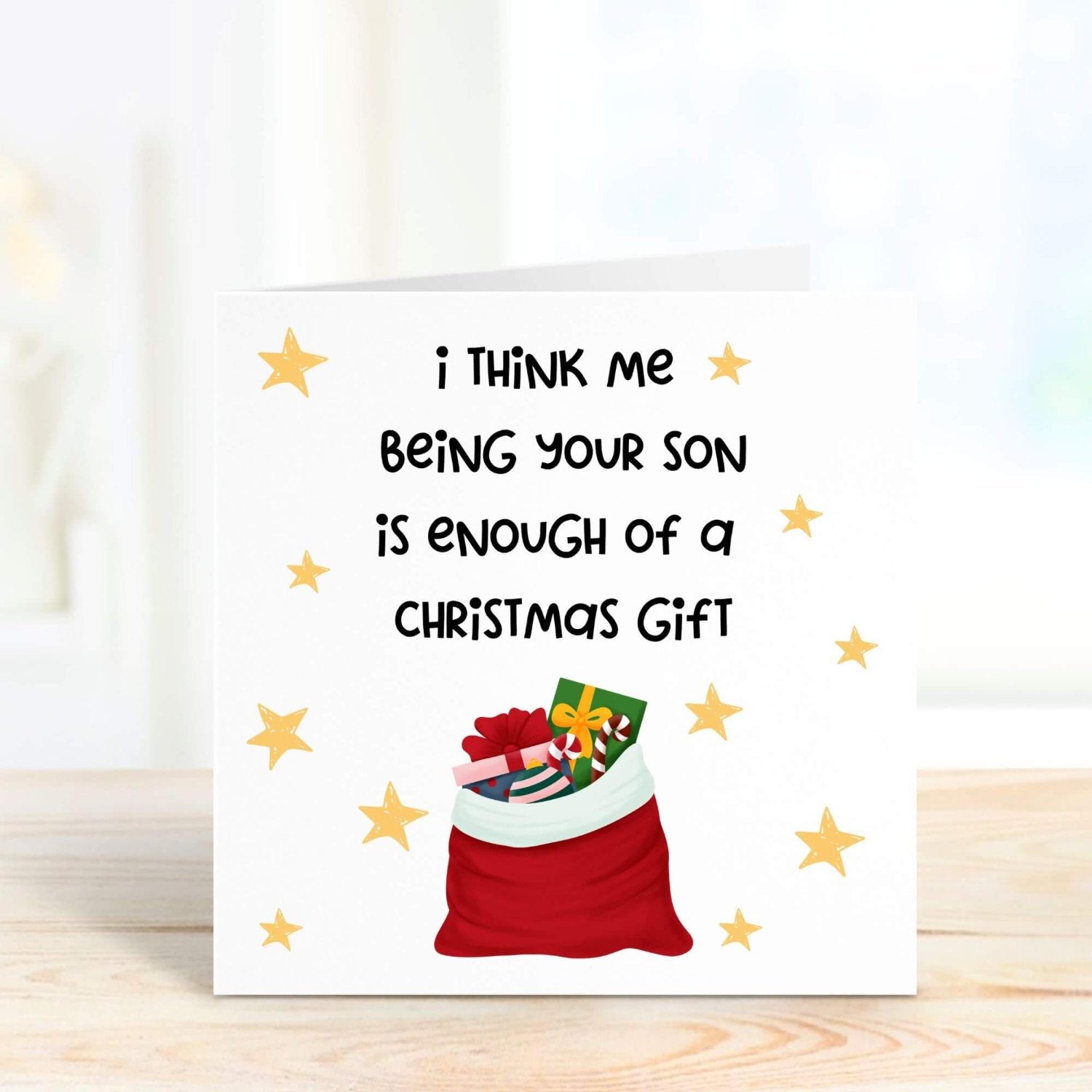 Humorous Christmas card for parents featuring a Santa sack filled with presents and golden stars, with the playful message, "Me being your son is enough of a Christmas gift."