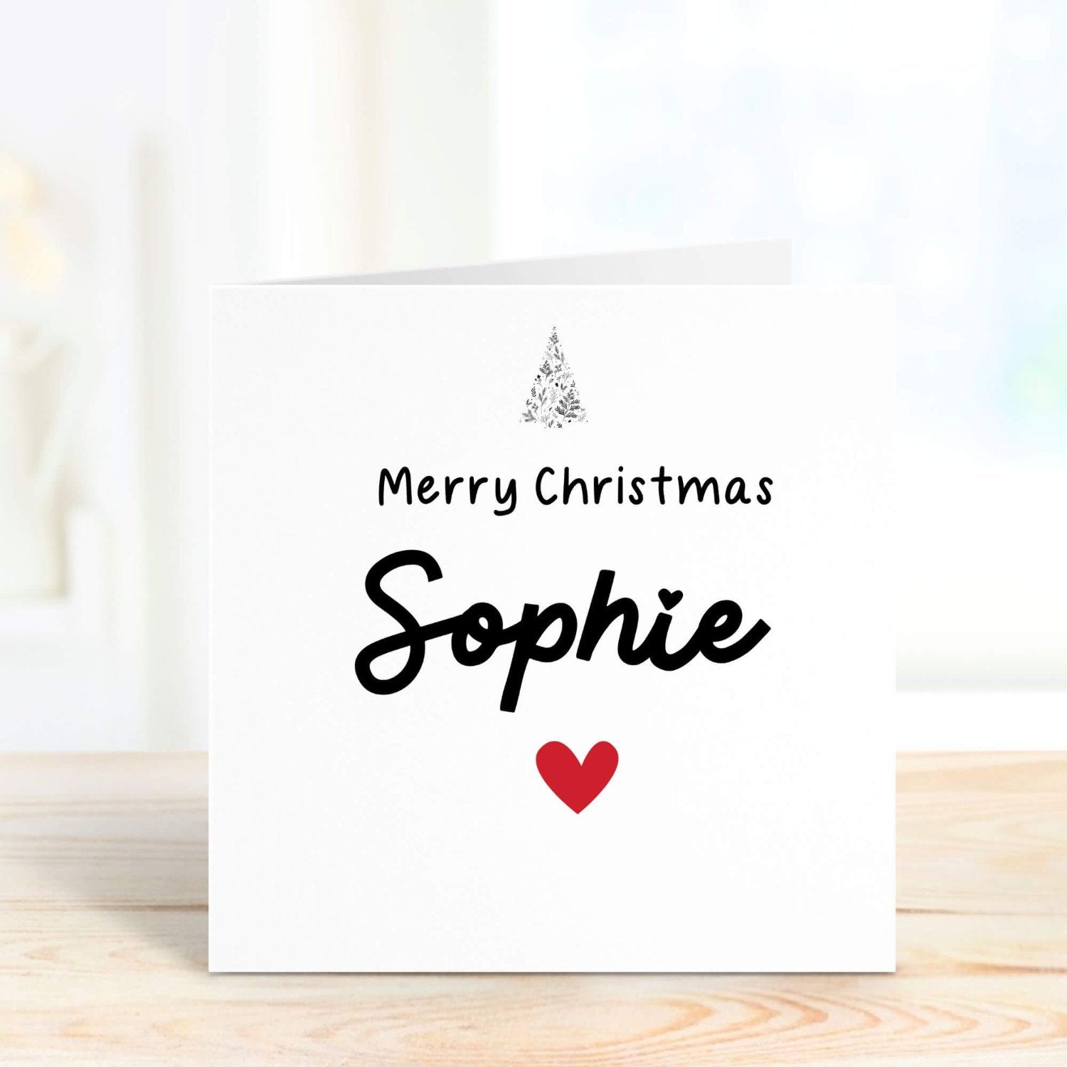 Customisable Christmas card with the message "Merry Christmas [Name]" and a red heart, ideal for creating personalised festive greetings for the holiday season.