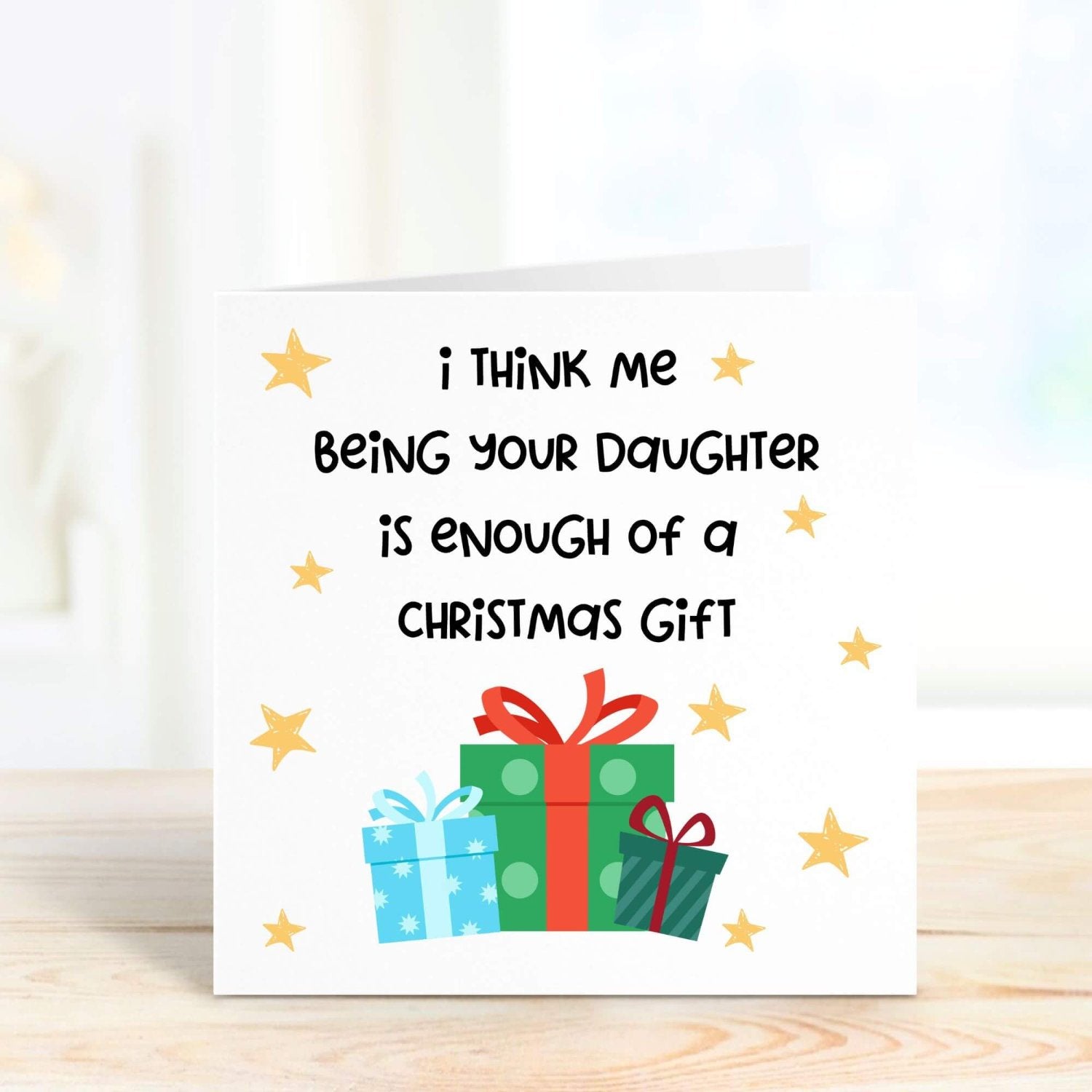 Humorous Christmas card for parents featuring gift boxes and stars, with the playful message, "Me being your daughter is enough of a Christmas gift."