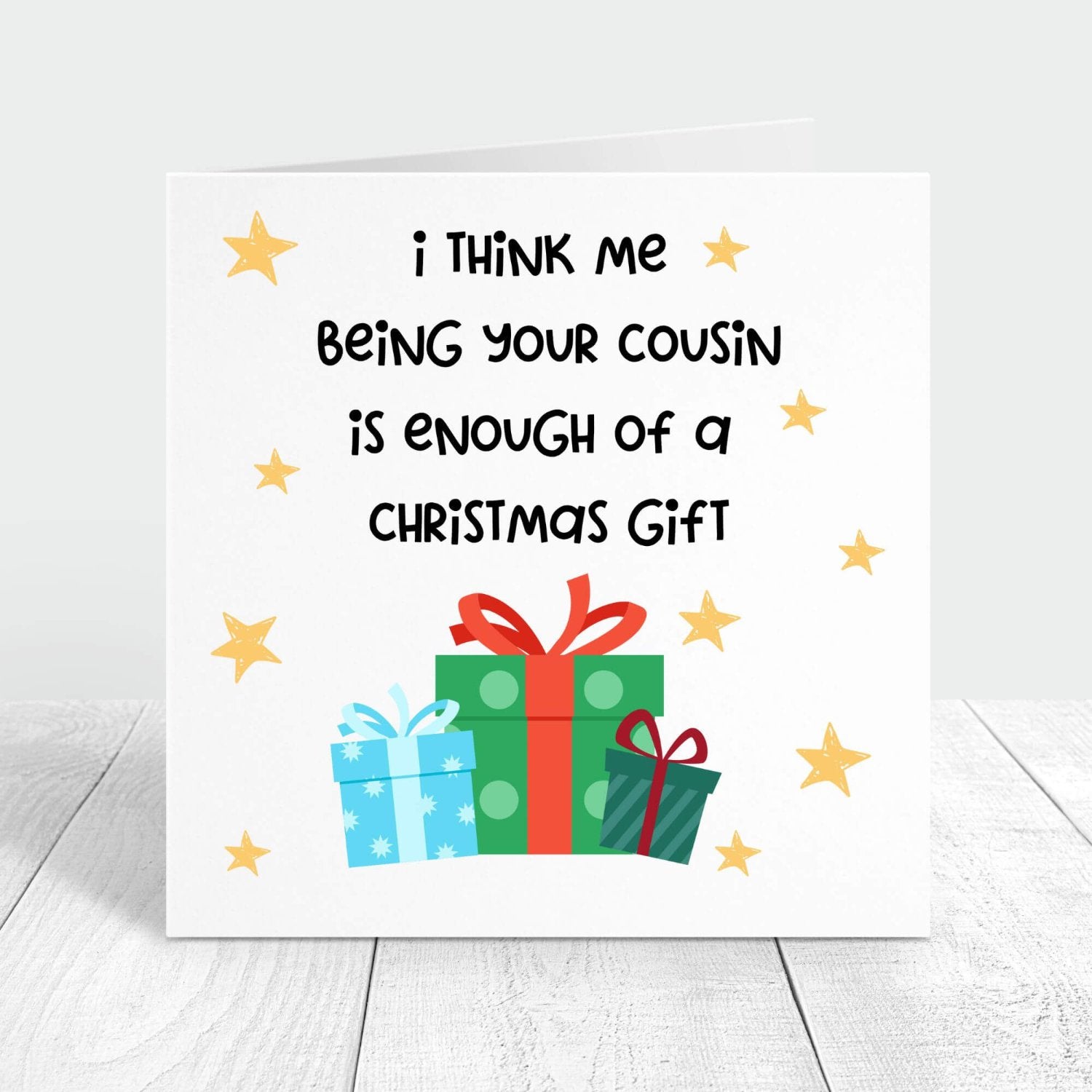 Funny Christmas card with the message "I think me being your cousin is enough of a Christmas gift," decorated with colourful presents and stars, perfect for a lighthearted holiday greeting.