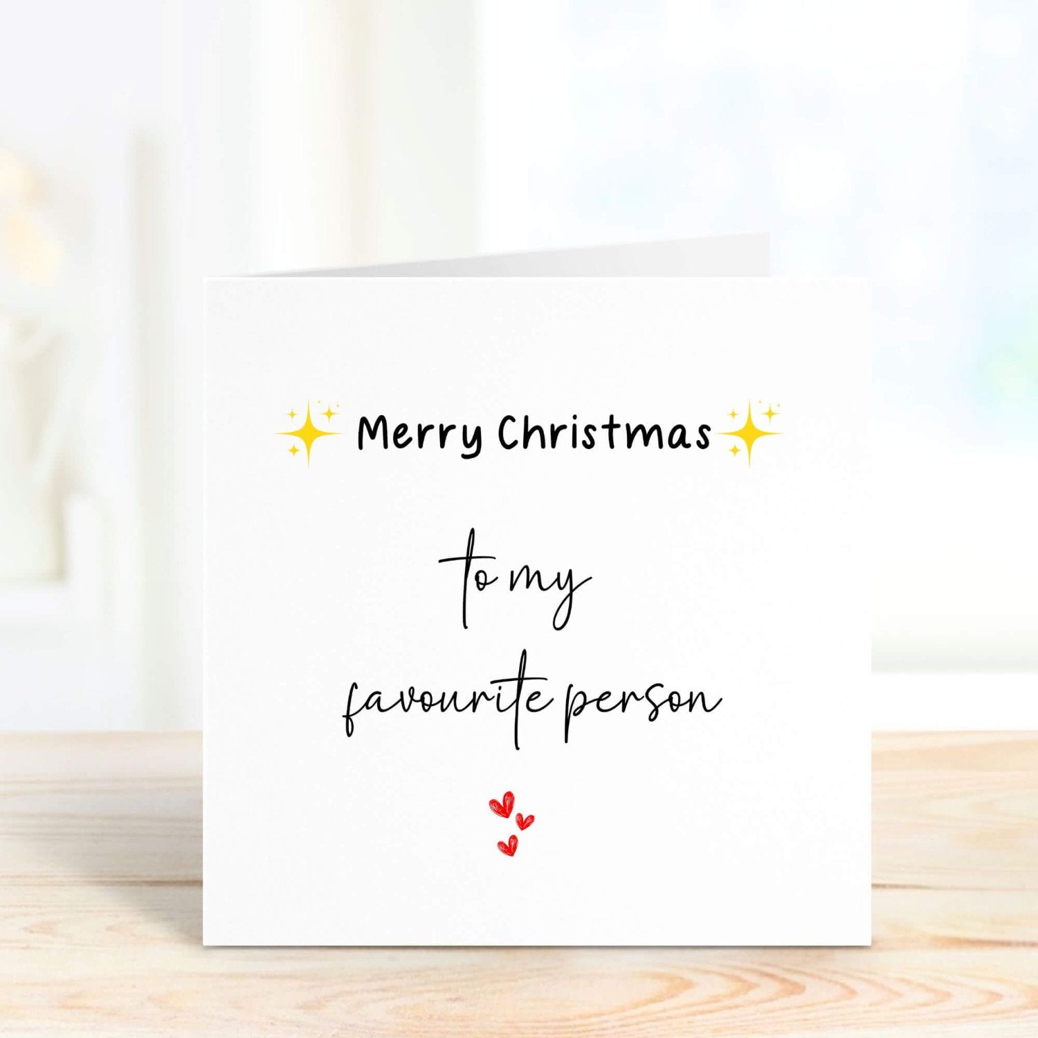 Front of a personalised Christmas card reading "Merry Christmas to my favourite person," with festive accents, perfect for sending to someone special during the holiday season.