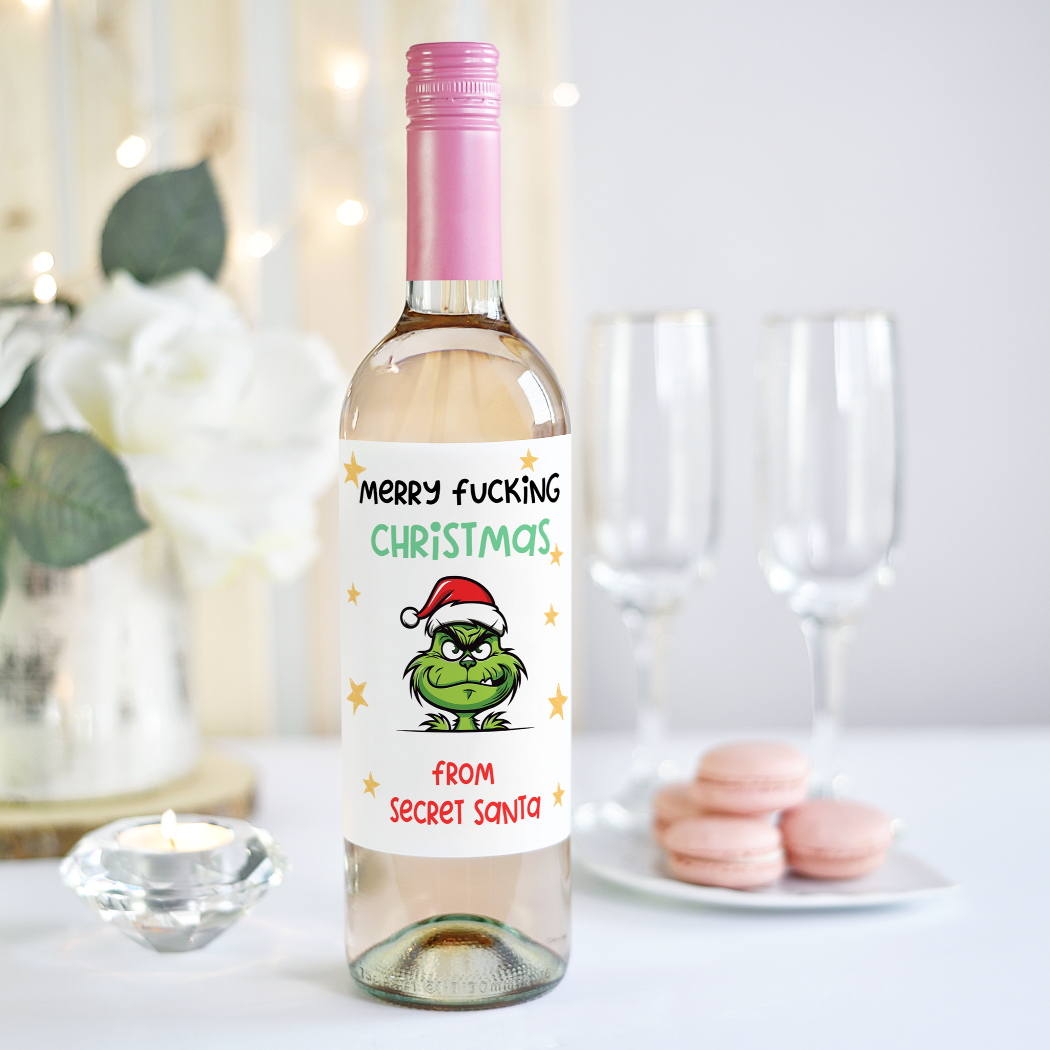 Funny Secret Santa wine label for Christmas, with the message 'Merry F*cking Christmas' and a festive grinch-like character.