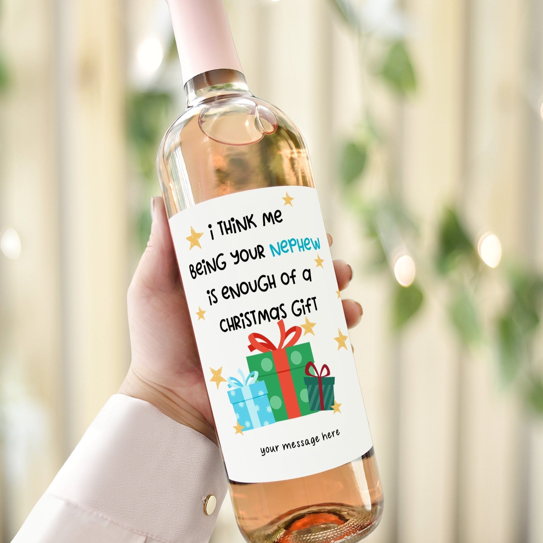 Wine bottle with a humorous Christmas label reading 'I think me being your nephew is enough of a Christmas gift,' featuring gift box graphics.