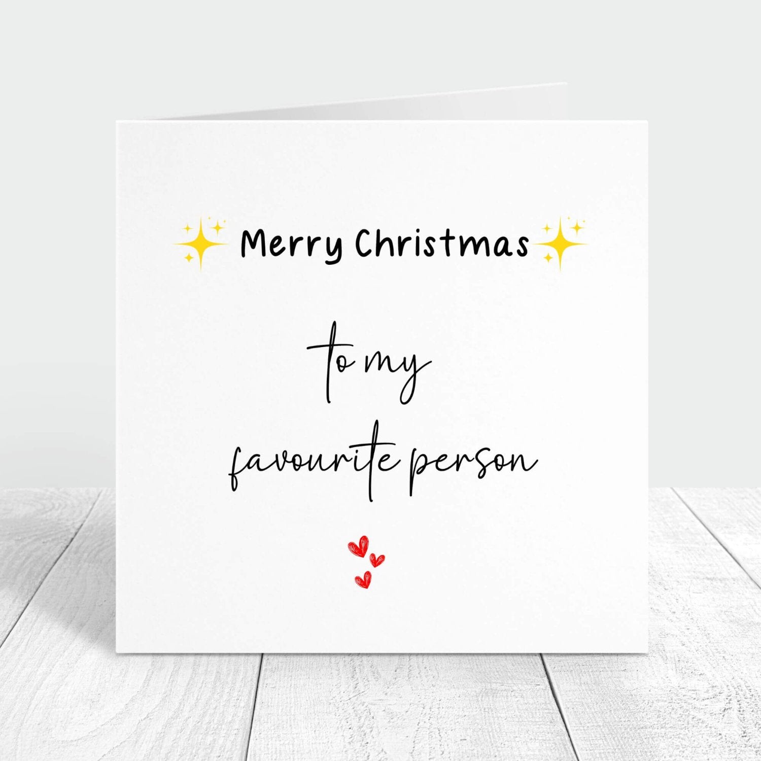 Personalised Christmas card with the message "Merry Christmas to my favourite person" featuring festive star icons and red hearts. Ideal for gifting to a loved one.