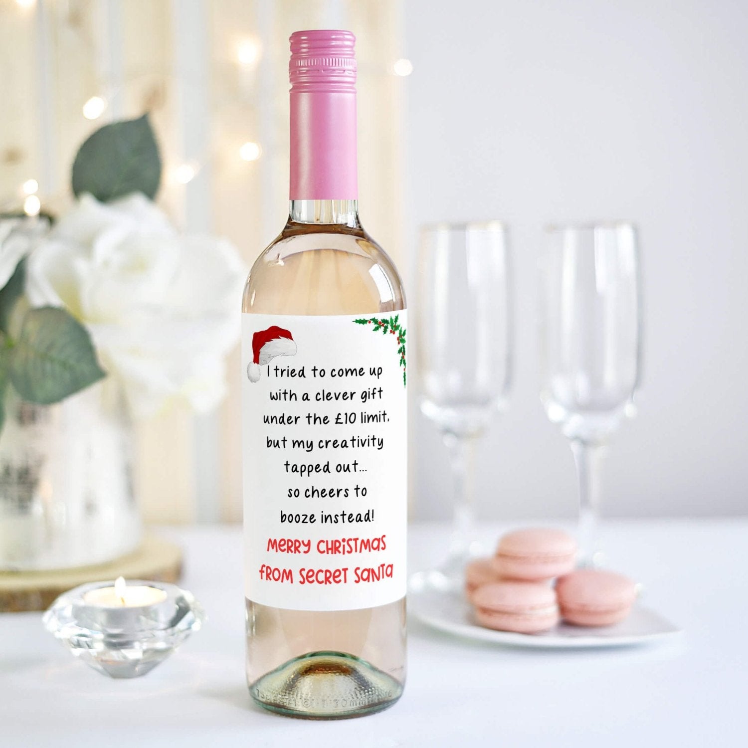 Festive wine bottle featuring a funny Secret Santa label perfect for holiday gift exchanges, decorated with a Santa hat and holly accents.